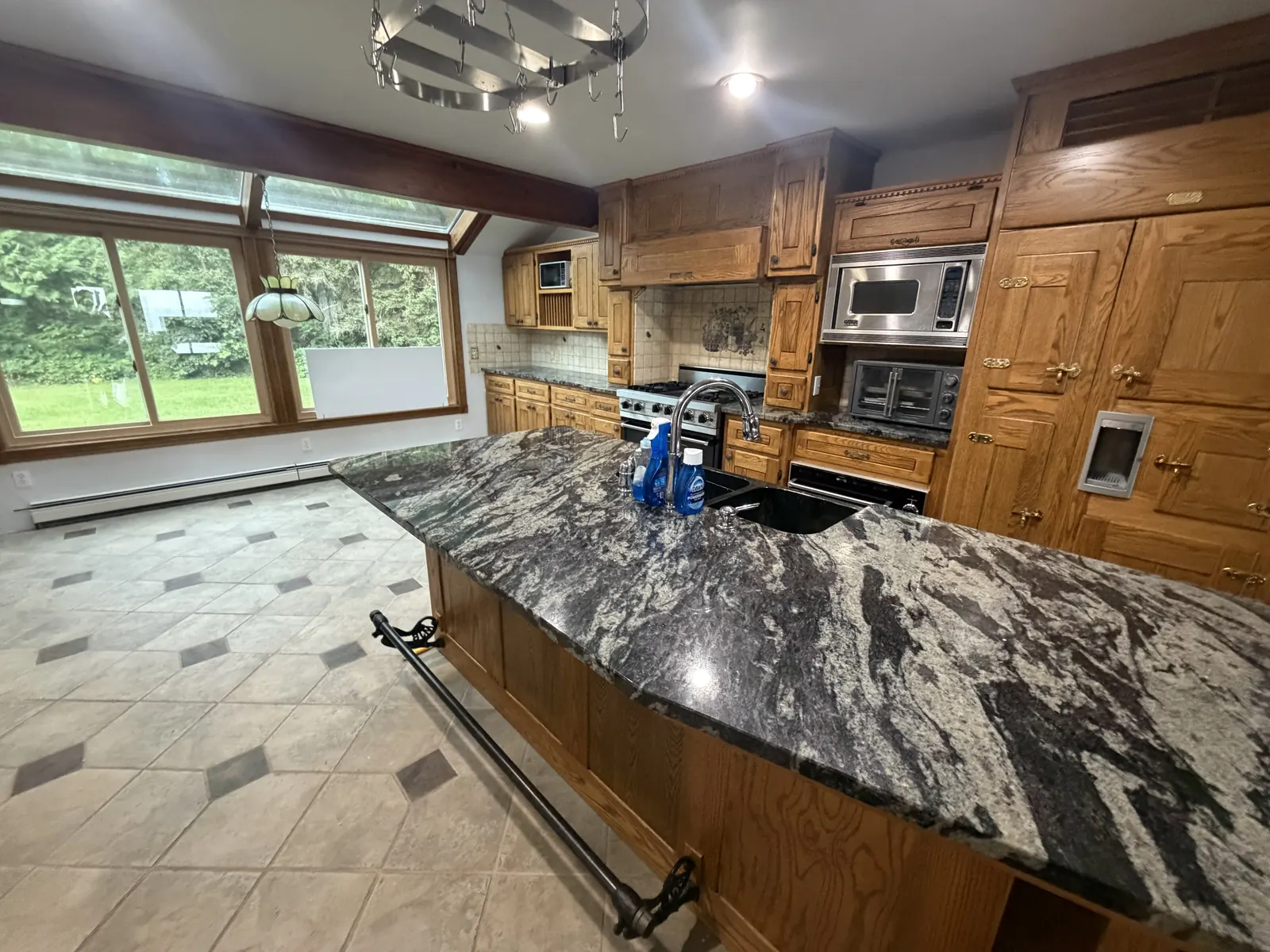 Cleared and cleaned kitchen with granite island, ready for listing photos