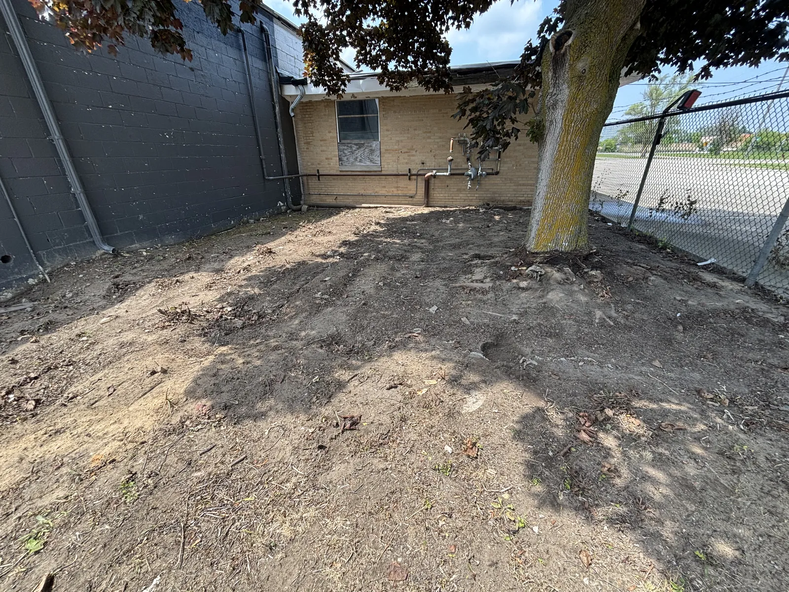The same yard cleared and graded after the deck removal