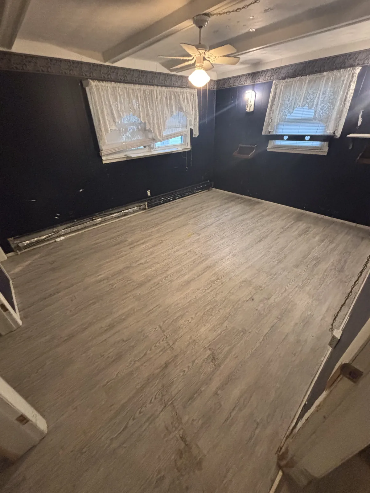 The same bedroom empty and swept after the cleanout
