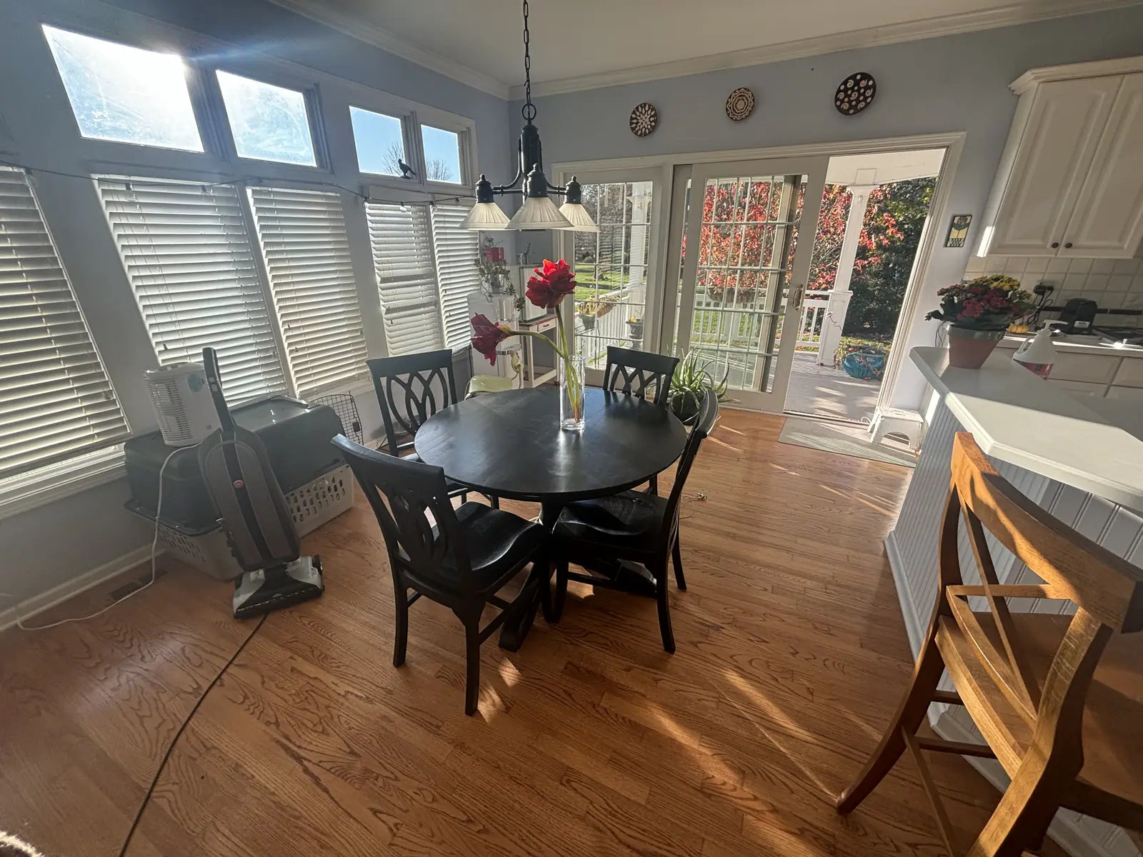 Sunny breakfast nook with a round dining table and chairs