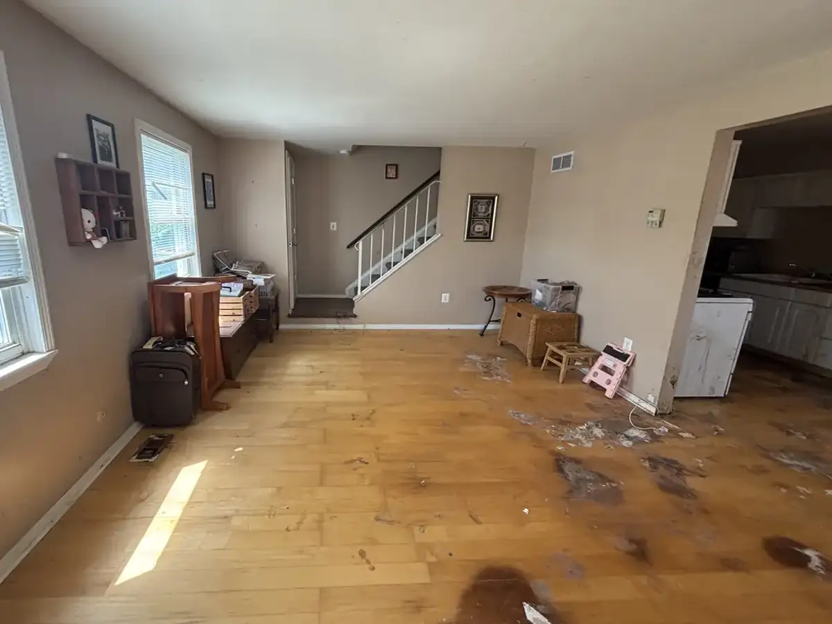 The same living room cleared and broom-clean after the cleanout